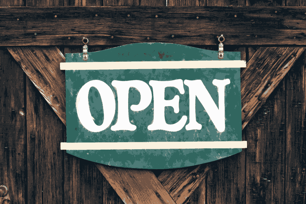 A wooden door with an open sign